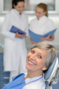 Senior woman patient at dentist surgery smiling copy