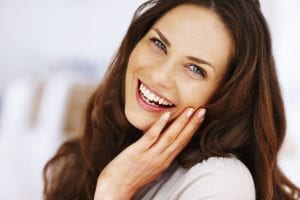 Brunette Female with Long Hair Smiling with Head Tilted