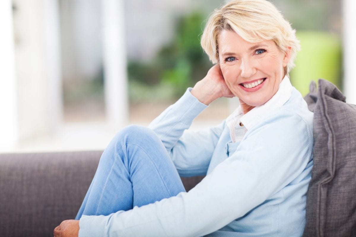 Blond Mature Female Reclining on Couch