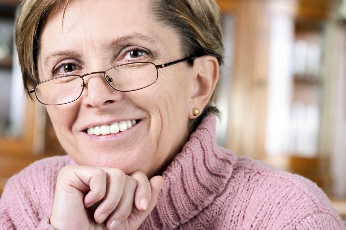 Mature Female with Glasses and Pink Sweater