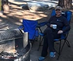 Dr. Beck Sitting at a Campsite Copy