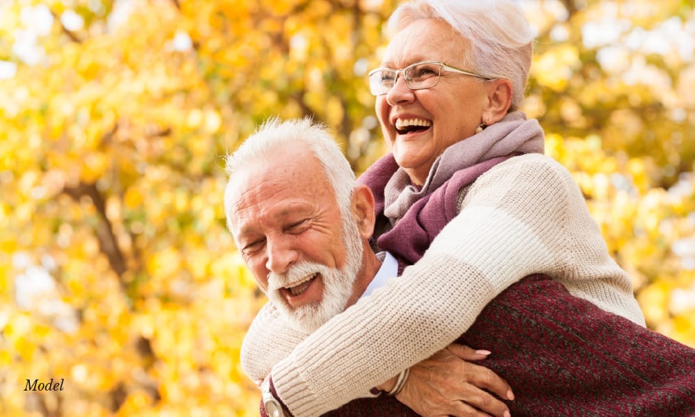Older Man Carrying Older Woman in His Back