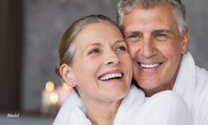 Couple in white robes smiling