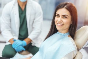 Smiling young woman receiving dental checkup close up view Healthcare and medicine concept